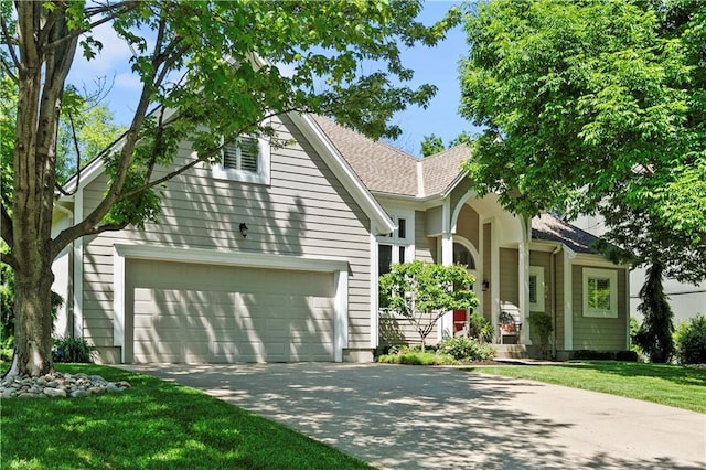 5510 W 153rd Ter, Overland Park, KS 66223 - view of front facade featuring concrete driveway, a front yard, a shingled roof, and an attached garage