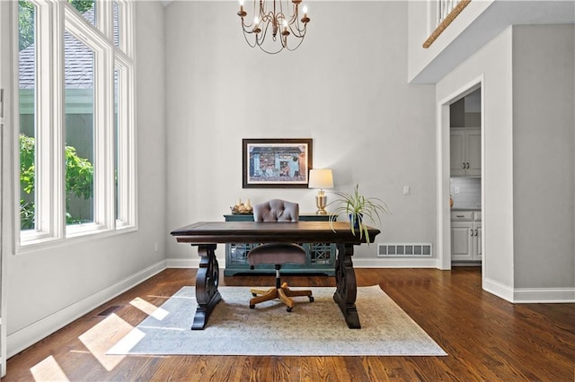 5510 W 153rd Ter, Overland Park, KS 66223 - office space with a chandelier, a towering ceiling, dark wood-type flooring, and baseboards