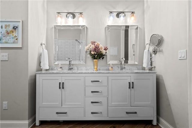 5510 W 153rd Ter, Overland Park, KS 66223 - bathroom featuring double vanity, wood finished floors, and baseboards
