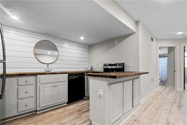 5510 W 153rd Ter, Overland Park, KS 66223 - kitchen featuring black dishwasher, wooden counters, electric range, light wood-style flooring, and white cabinetry