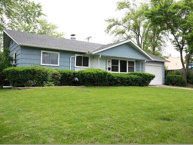 single story home featuring a chimney, a front yard, and a garage