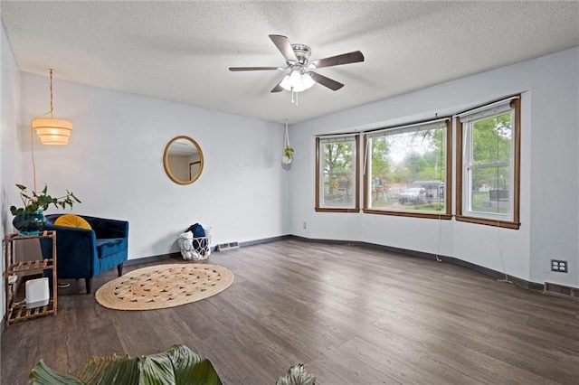 unfurnished room featuring a textured ceiling, ceiling fan, and wood finished floors
