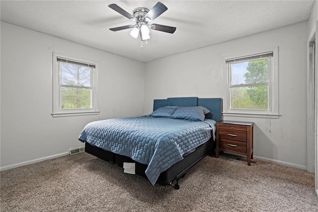 bedroom with carpet floors, a textured ceiling, and baseboards
