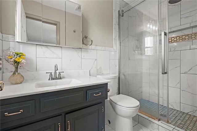 full bath featuring vanity, marble finish floor, toilet, and a shower stall