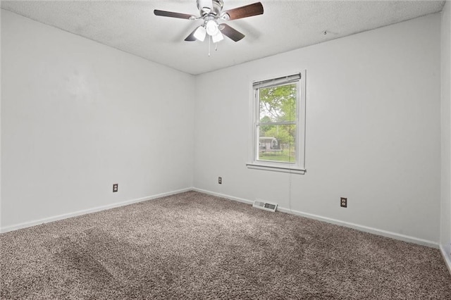 carpeted empty room with baseboards, ceiling fan, a textured ceiling, and visible vents