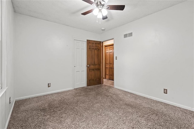 spare room with visible vents, carpet, and baseboards