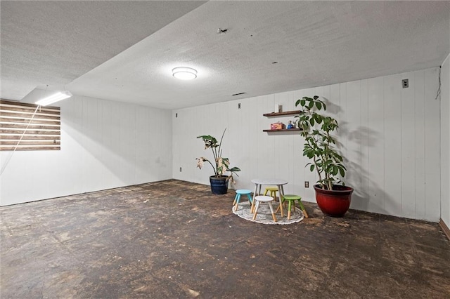 finished basement with a textured ceiling