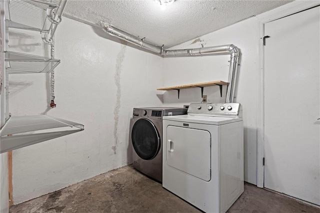laundry area with laundry area, a textured ceiling, and independent washer and dryer
