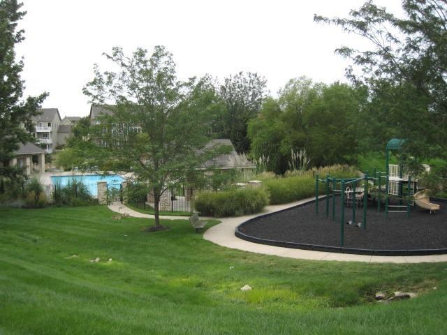 view of property's community featuring a lawn and playground community