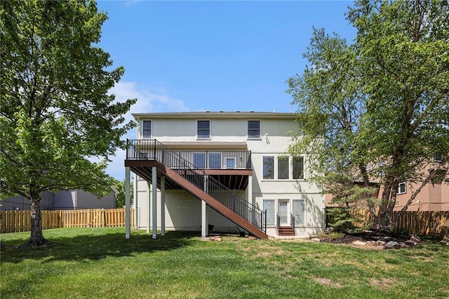 back of house featuring fence, a wooden deck, a yard, and stairway