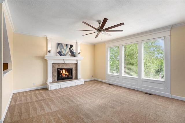 unfurnished living room with ornamental molding, ceiling fan, and a fireplace