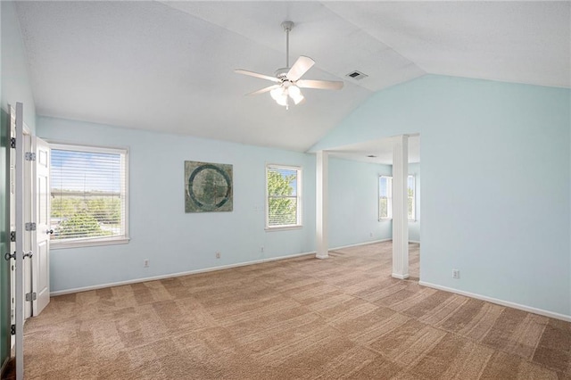 spare room with visible vents, lofted ceiling, baseboards, ceiling fan, and light colored carpet