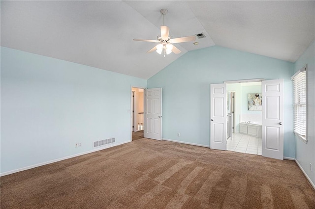 unfurnished bedroom with visible vents, baseboards, carpet, and lofted ceiling