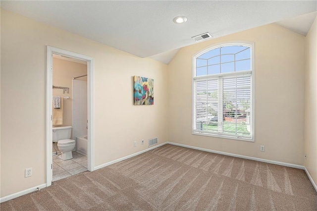 unfurnished bedroom featuring baseboards, carpet flooring, and visible vents