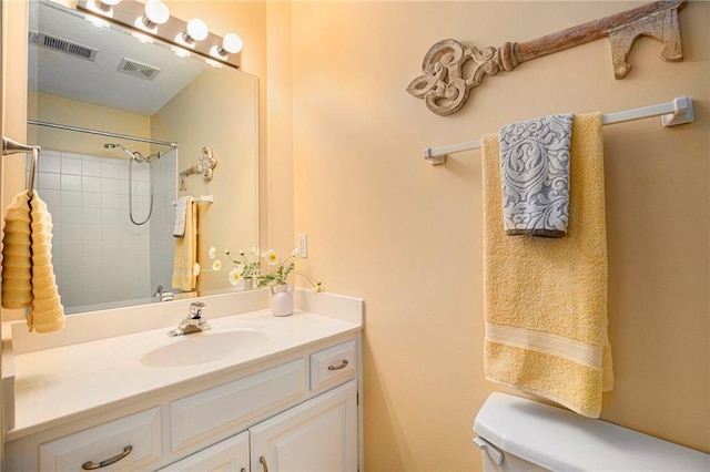 full bathroom featuring walk in shower, toilet, visible vents, and vanity