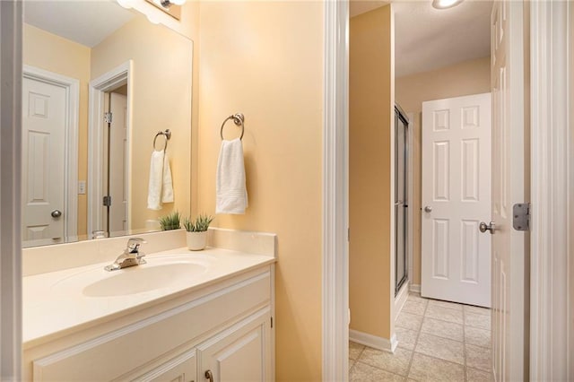 bathroom featuring an enclosed shower, baseboards, and vanity