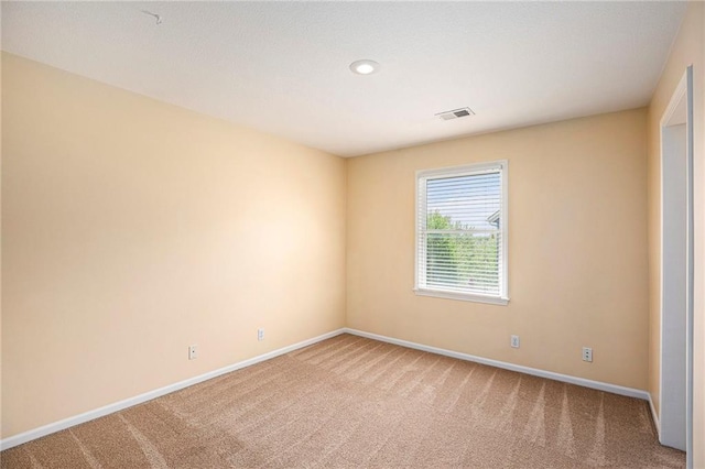 carpeted empty room with recessed lighting, baseboards, and visible vents