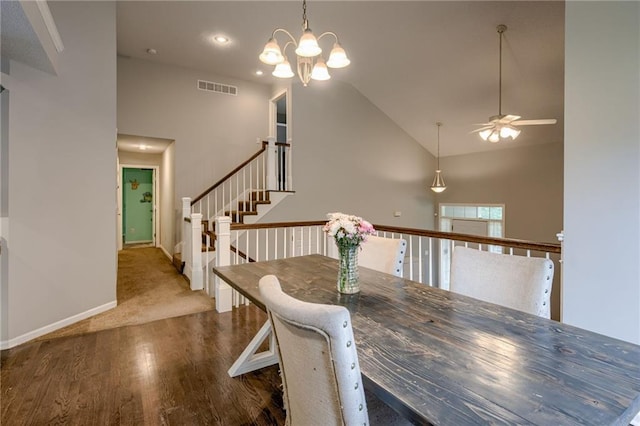 18716 W 164th Ter, Olathe, KS 66062 - dining room featuring wood finished floors, a ceiling fan, a chandelier, high vaulted ceiling, and baseboards