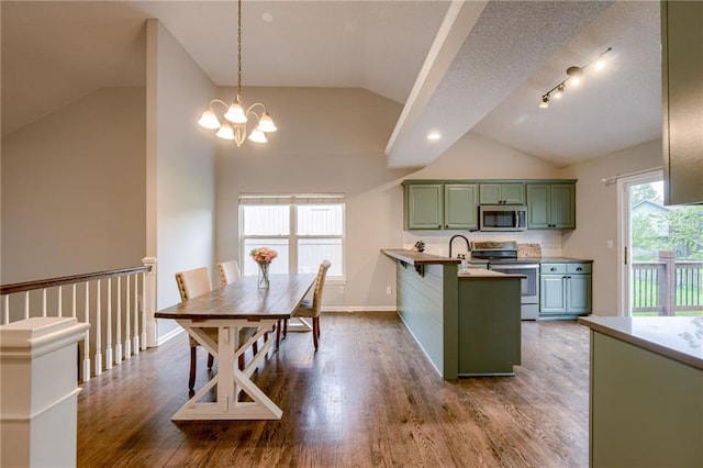 18716 W 164th Ter, Olathe, KS 66062 - kitchen with appliances with stainless steel finishes, green cabinetry, vaulted ceiling, a peninsula, and dark wood-style floors