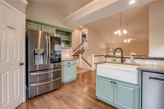 18716 W 164th Ter, Olathe, KS 66062 - kitchen with stainless steel appliances, vaulted ceiling, a sink, a chandelier, and wood finished floors