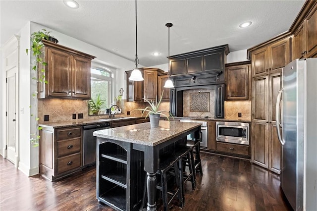 kitchen featuring stainless steel appliances, dark wood-style flooring, open shelves, a kitchen island, and recessed lighting