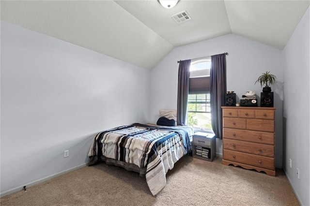 carpeted bedroom featuring lofted ceiling and baseboards