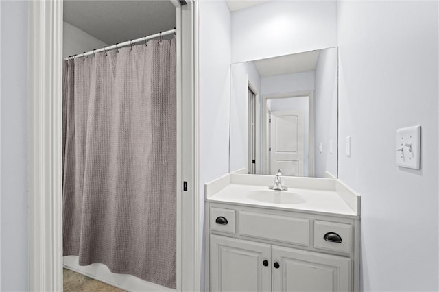 bathroom featuring vanity and curtained shower