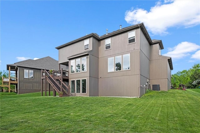 rear view of property with a lawn, a deck, stairs, and cooling unit
