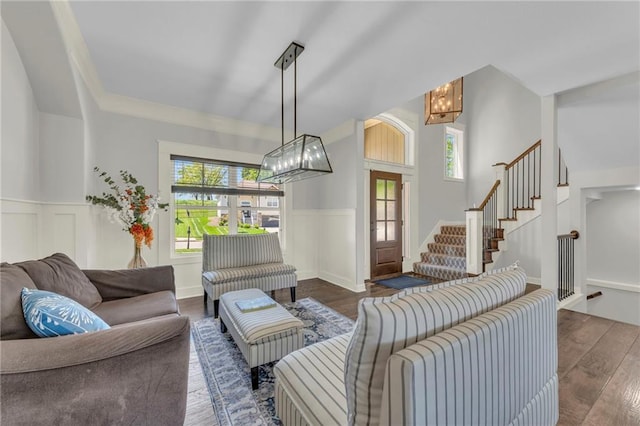 12765 N Imperial Dr, Platte City, MO 64079 - living area with a chandelier, wood finished floors, a wainscoted wall, stairway, and a decorative wall