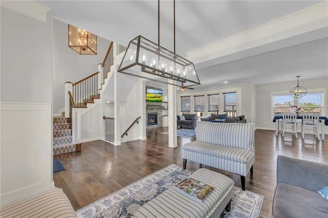 12765 N Imperial Dr, Platte City, MO 64079 - living area featuring a chandelier, wood finished floors, stairway, baseboards, and a fireplace