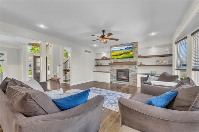 12765 N Imperial Dr, Platte City, MO 64079 - living area featuring healthy amount of natural light, stairway, a stone fireplace, ceiling fan, and recessed lighting