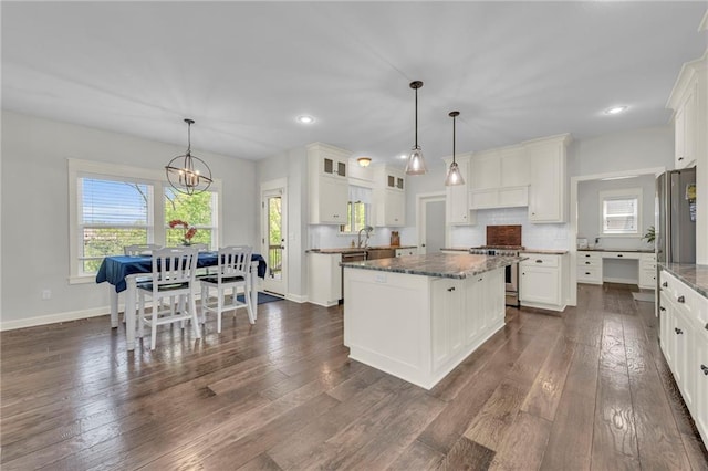 12765 N Imperial Dr, Platte City, MO 64079 - kitchen with a center island, stainless steel appliances, white cabinets, dark wood finished floors, and dark stone countertops