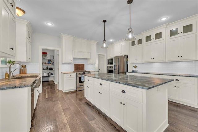 12765 N Imperial Dr, Platte City, MO 64079 - kitchen featuring stainless steel appliances, backsplash, white cabinetry, glass insert cabinets, and recessed lighting