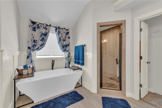 12765 N Imperial Dr, Platte City, MO 64079 - bathroom with a shower stall, a freestanding tub, lofted ceiling, and a wainscoted wall