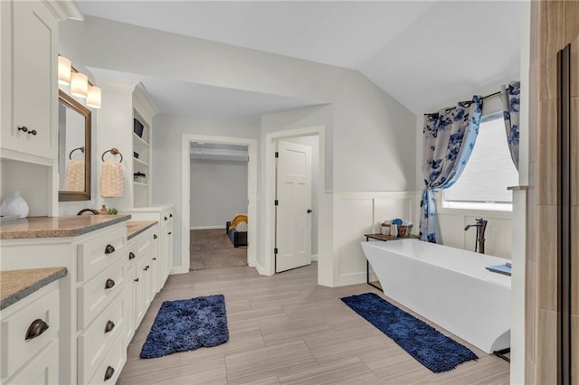 12765 N Imperial Dr, Platte City, MO 64079 - full bath with a freestanding tub, vaulted ceiling, and vanity