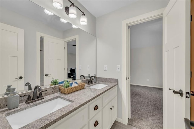 12765 N Imperial Dr, Platte City, MO 64079 - full bathroom with double vanity and baseboards
