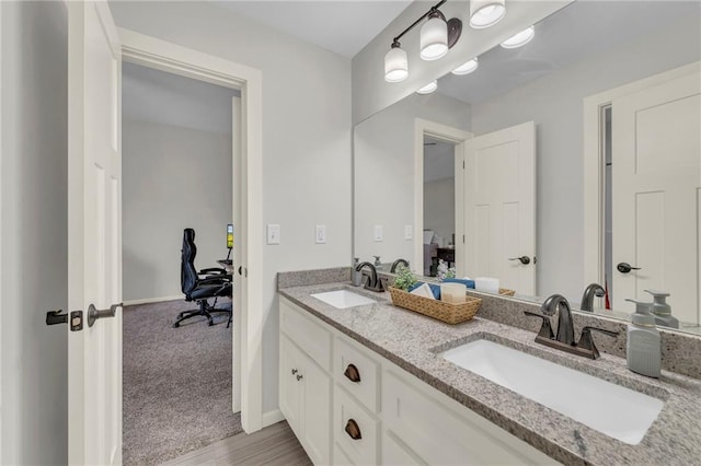 12765 N Imperial Dr, Platte City, MO 64079 - bathroom featuring double vanity and baseboards