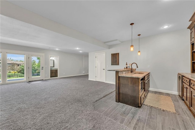 12765 N Imperial Dr, Platte City, MO 64079 - kitchen with baseboards, a sink, hanging light fixtures, light stone counters, and recessed lighting