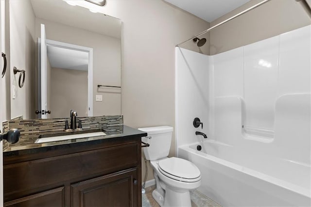 bathroom with toilet, vanity, washtub / shower combination, and decorative backsplash