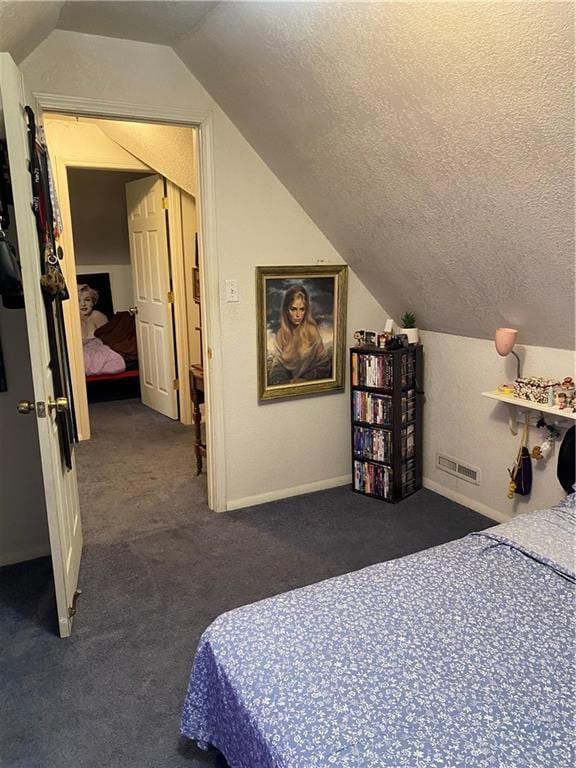 bedroom with a textured ceiling, visible vents, vaulted ceiling, and carpet floors