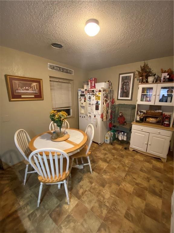 dining area featuring a textured ceiling