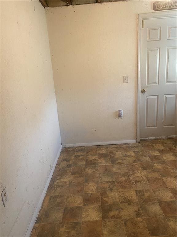 spare room featuring baseboards