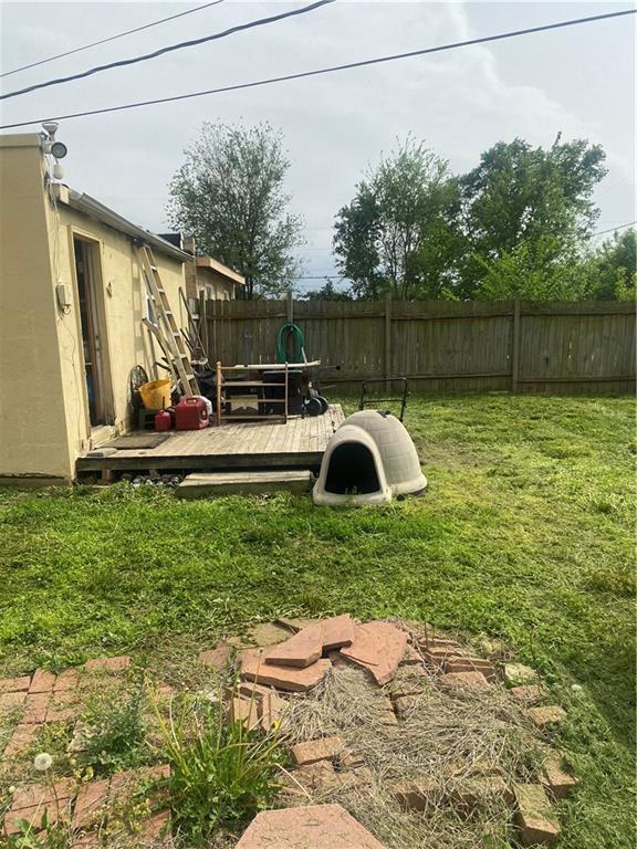 view of yard featuring a wooden deck and fence