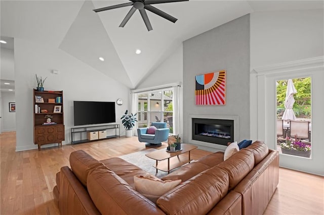 9818 Overbrook Ct, Leawood, KS 66206 - living room with a glass covered fireplace, high vaulted ceiling, ceiling fan, and light wood finished floors