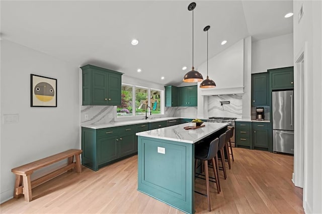 9818 Overbrook Ct, Leawood, KS 66206 - kitchen with a breakfast bar, light wood-style floors, backsplash, green cabinets, and stainless steel appliances