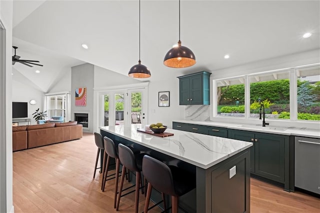 9818 Overbrook Ct, Leawood, KS 66206 - kitchen featuring stainless steel dishwasher, lofted ceiling, plenty of natural light, recessed lighting, and a sink