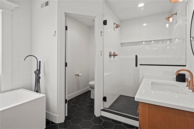 9818 Overbrook Ct, Leawood, KS 66206 - full bath with visible vents, tile patterned flooring, a stall shower, vanity, and toilet