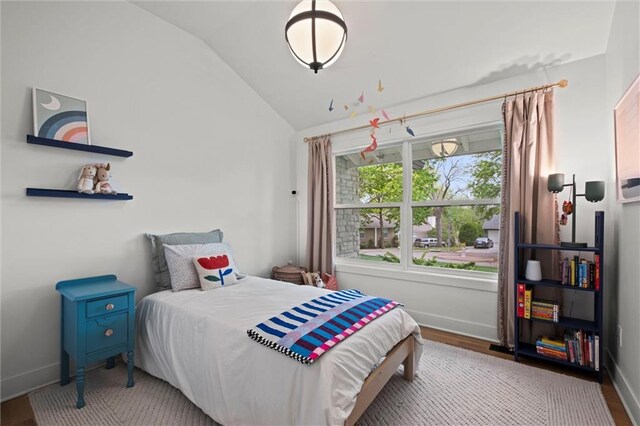 9818 Overbrook Ct, Leawood, KS 66206 - bedroom featuring baseboards, wood finished floors, and lofted ceiling