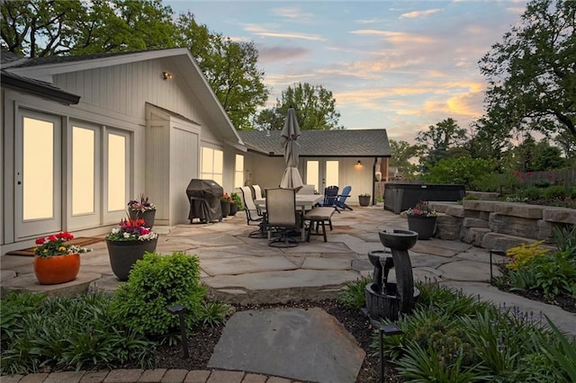 9818 Overbrook Ct, Leawood, KS 66206 - rear view of house featuring a hot tub, a patio, and outdoor dining area