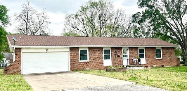 single story home featuring brick siding, a garage, and driveway
